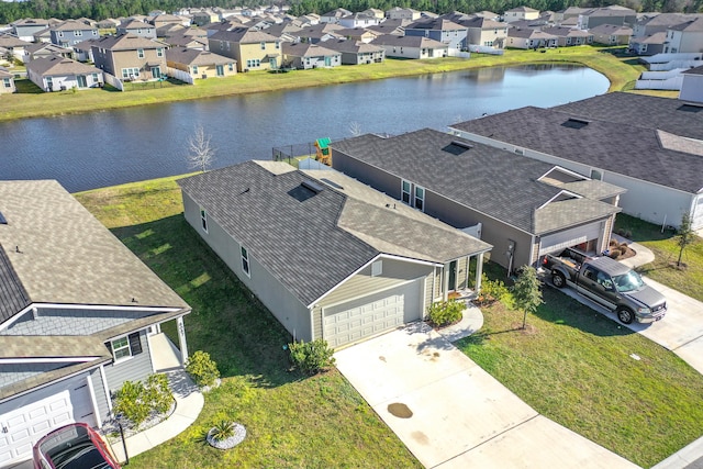 drone / aerial view with a residential view and a water view