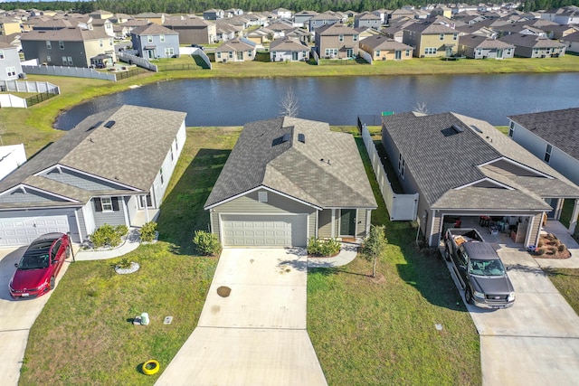 bird's eye view with a residential view and a water view