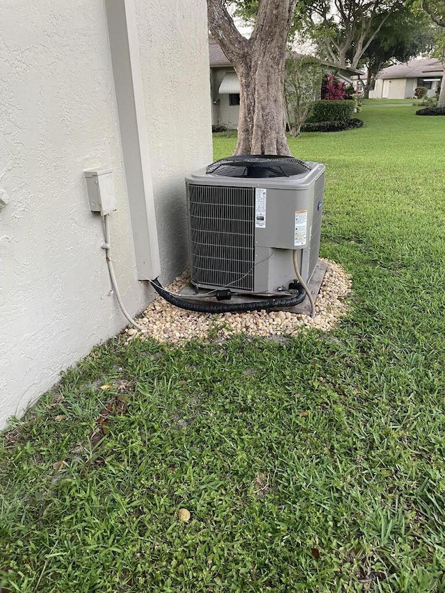 exterior details with cooling unit and stucco siding