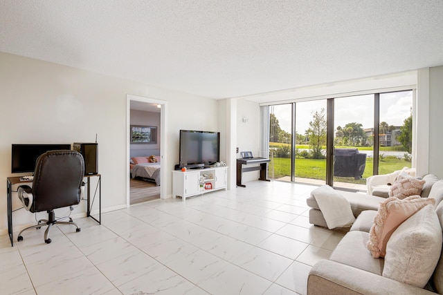 living room featuring marble finish floor, floor to ceiling windows, and a textured ceiling