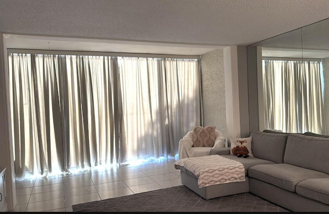 living room featuring tile patterned flooring and a textured ceiling