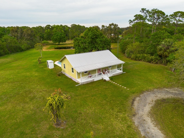 drone / aerial view featuring a wooded view