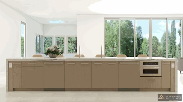 interior space with light stone counters, dishwasher, stainless steel oven, and a sink