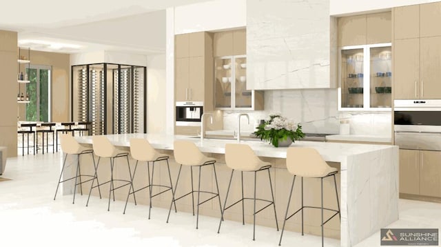 kitchen with tasteful backsplash, a center island with sink, a breakfast bar, and oven