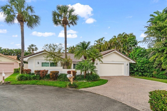 single story home with a garage and decorative driveway