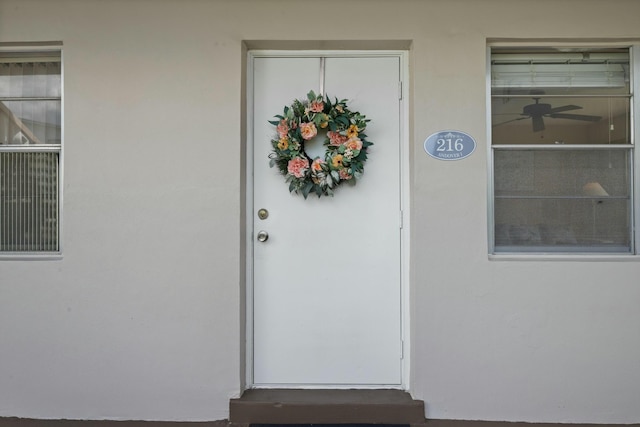 entrance to property with stucco siding