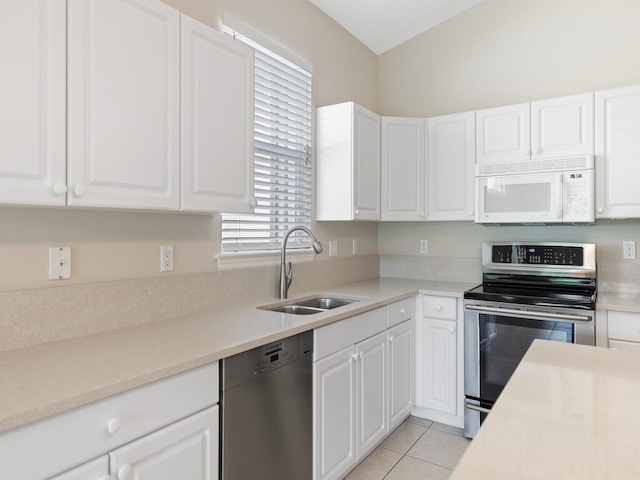 kitchen with white cabinetry, stainless steel appliances, and a sink