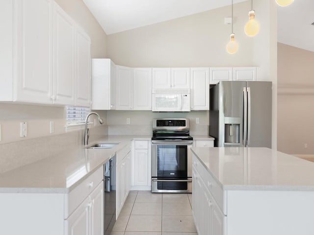 kitchen featuring vaulted ceiling, stainless steel appliances, light tile patterned flooring, and a sink