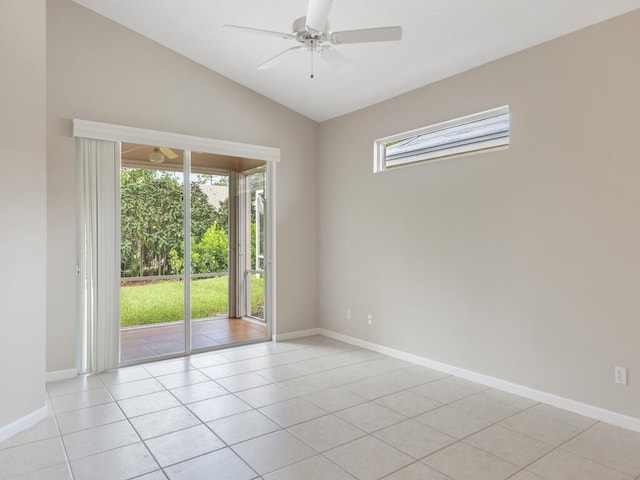 empty room with a wealth of natural light, ceiling fan, lofted ceiling, and baseboards