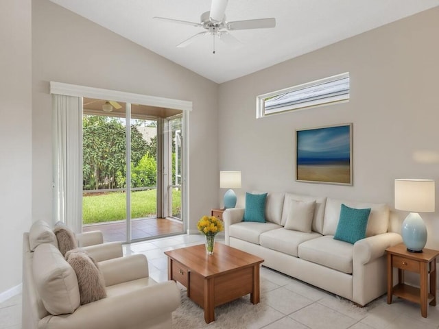 living room with a ceiling fan, plenty of natural light, light tile patterned flooring, and vaulted ceiling