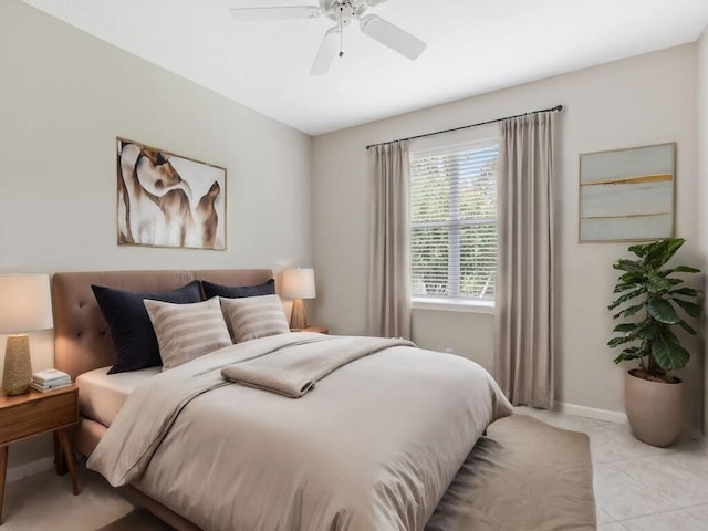 bedroom featuring ceiling fan, baseboards, and light tile patterned floors