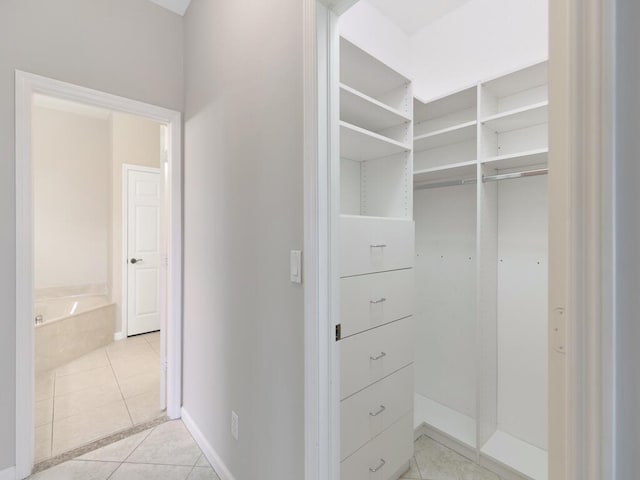 spacious closet featuring light tile patterned flooring