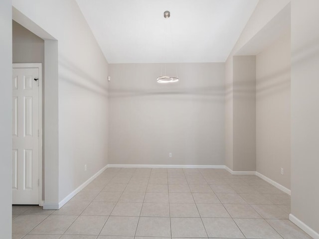 spare room featuring light tile patterned floors and baseboards