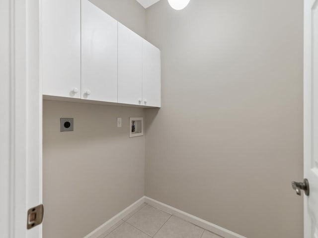 washroom with hookup for a washing machine, cabinet space, hookup for an electric dryer, light tile patterned flooring, and baseboards