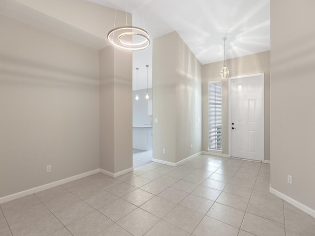 entryway featuring light tile patterned floors and baseboards