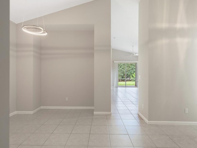 unfurnished room featuring light tile patterned floors, high vaulted ceiling, a ceiling fan, and baseboards