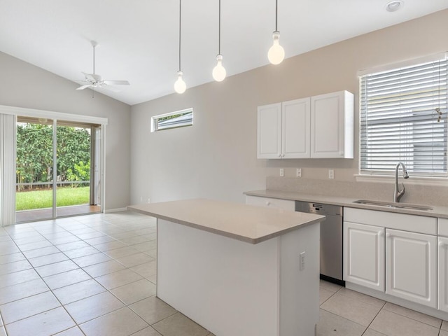 kitchen with ceiling fan, a sink, light countertops, stainless steel dishwasher, and a center island