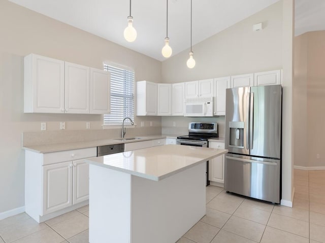 kitchen featuring appliances with stainless steel finishes, a sink, and white cabinetry