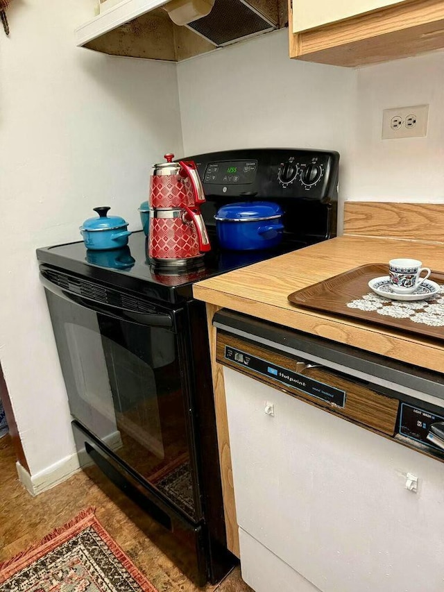 kitchen with dishwasher, black range with electric stovetop, baseboards, and under cabinet range hood