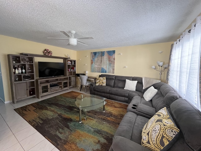 tiled living room featuring ceiling fan and a textured ceiling