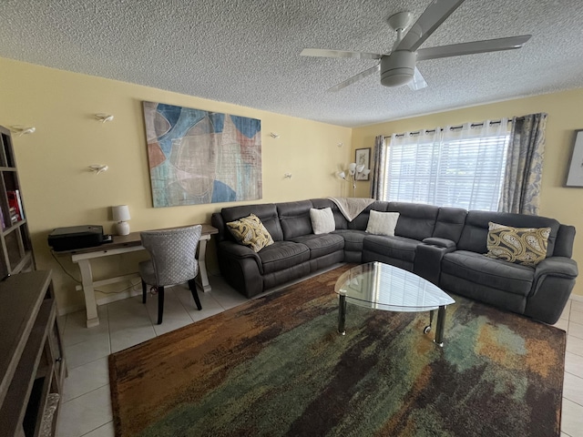 living area with ceiling fan, a textured ceiling, and light tile patterned flooring