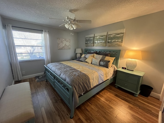 bedroom with baseboards, ceiling fan, a textured ceiling, and hardwood / wood-style floors