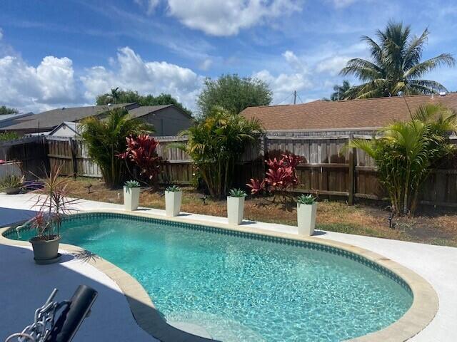 view of swimming pool with a fenced in pool and a fenced backyard