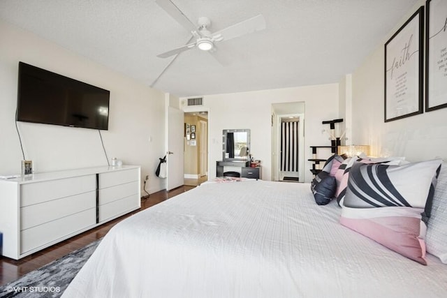 bedroom featuring visible vents, ceiling fan, and wood finished floors