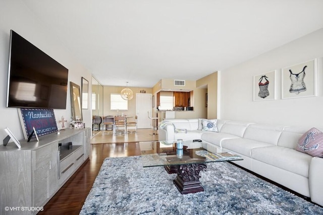 living area with visible vents and dark wood-type flooring