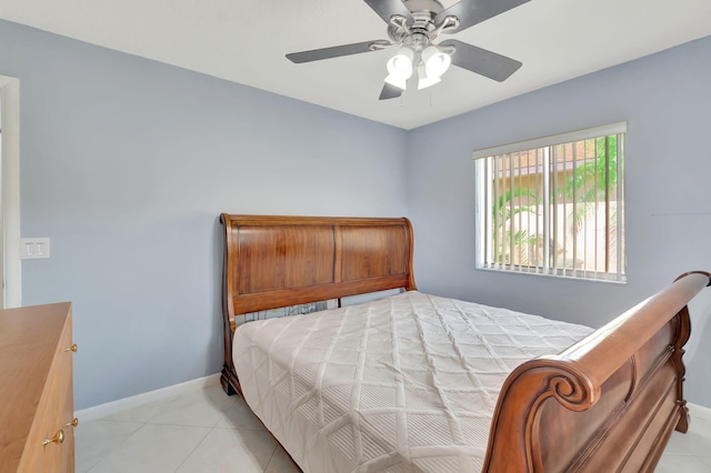 bedroom featuring light tile patterned floors, a ceiling fan, and baseboards