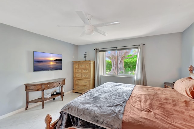 bedroom featuring light tile patterned flooring, ceiling fan, and baseboards