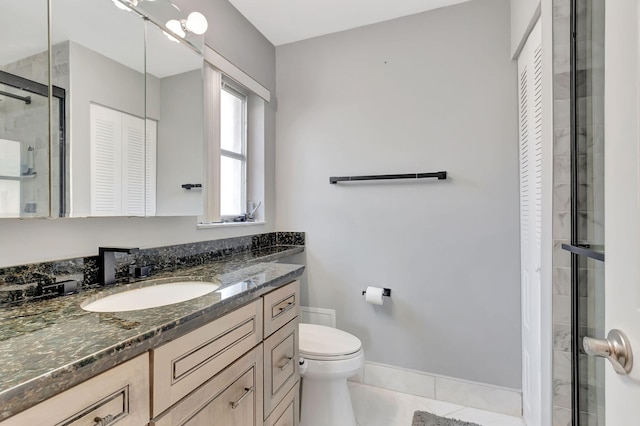 full bathroom with a closet, toilet, a stall shower, vanity, and tile patterned flooring