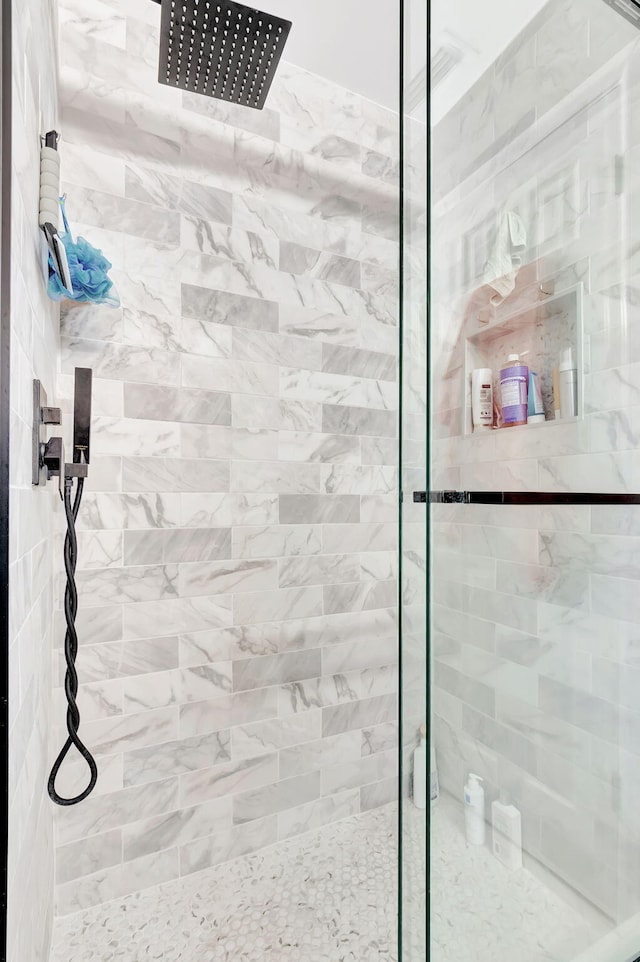 full bath featuring a tile shower