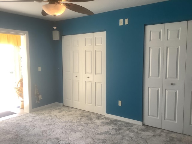 unfurnished bedroom with carpet flooring, a ceiling fan, and baseboards