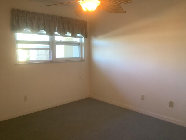 empty room with baseboards and ceiling fan