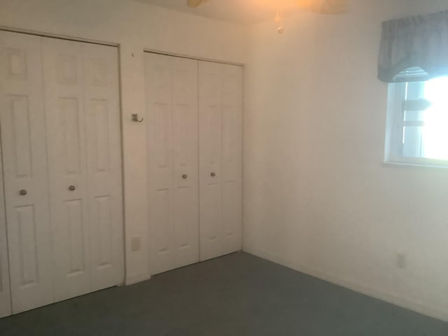 unfurnished bedroom with multiple closets