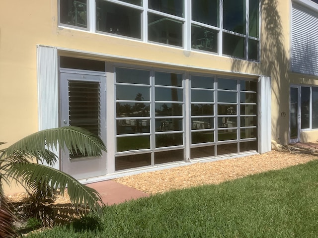 view of property exterior featuring stucco siding and a garage