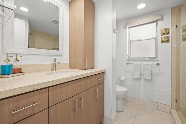 bathroom featuring vanity, baseboards, visible vents, tile patterned floors, and toilet