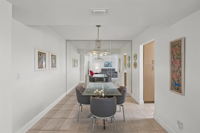 dining area featuring light tile patterned flooring, visible vents, a chandelier, and baseboards