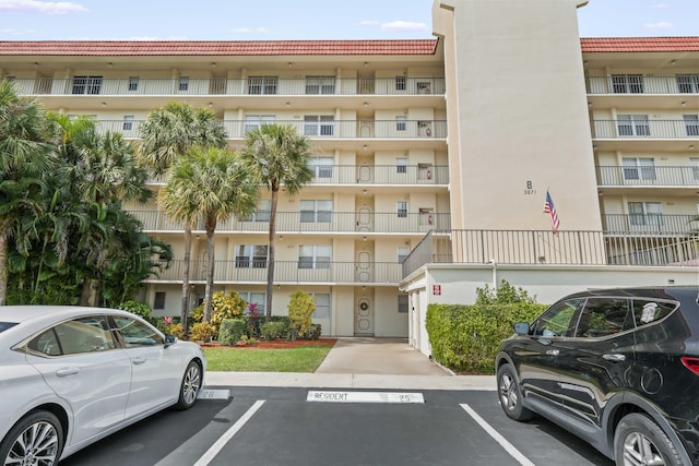 view of building exterior with uncovered parking