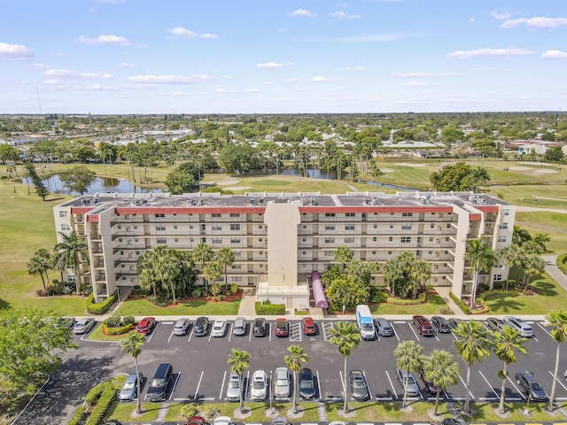 drone / aerial view featuring a water view and golf course view