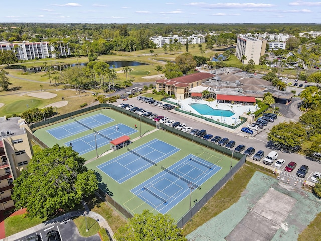 birds eye view of property with a water view and view of golf course