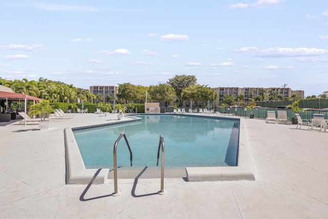 community pool featuring a patio area and fence