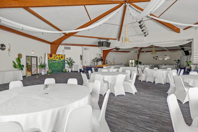 dining area with beam ceiling, carpet flooring, and high vaulted ceiling