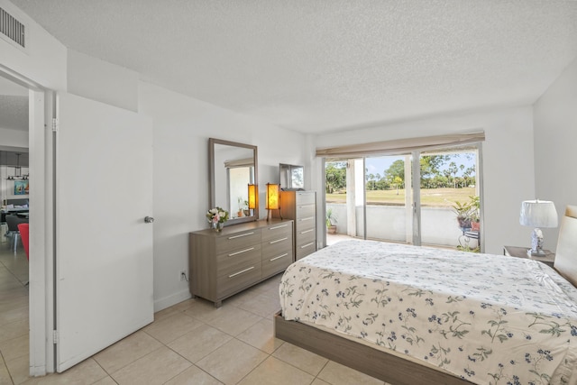 bedroom with visible vents, access to outside, a textured ceiling, light tile patterned floors, and baseboards