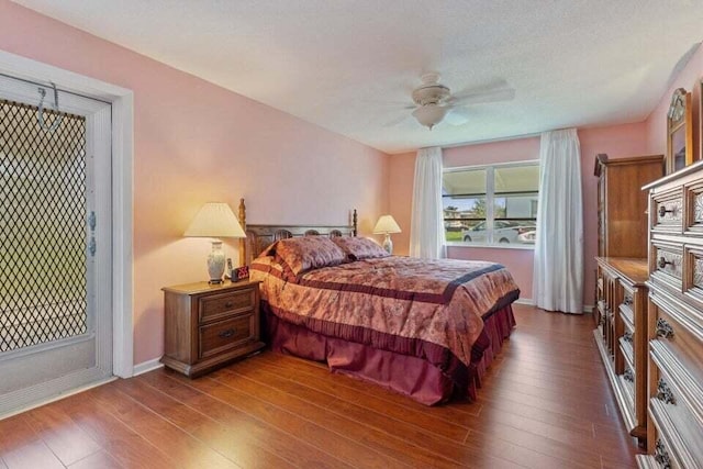 bedroom with wood-type flooring, baseboards, and a ceiling fan