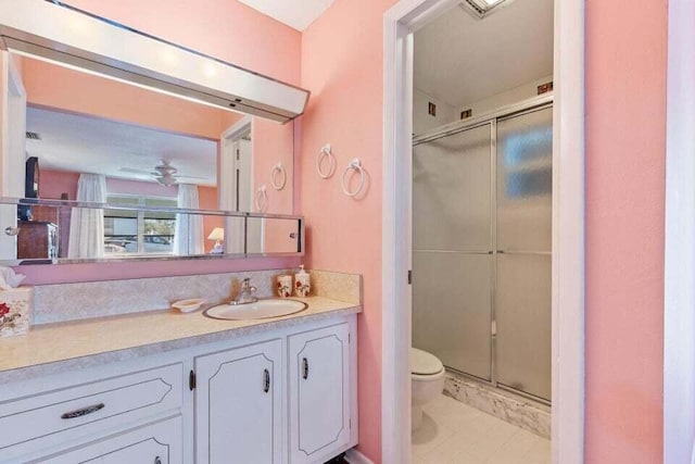 bathroom featuring a stall shower, vanity, and toilet