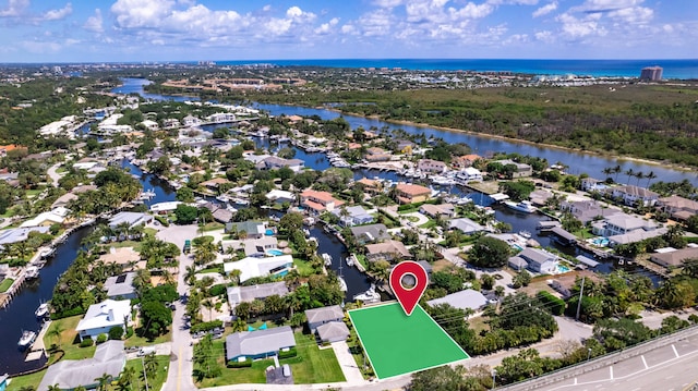 drone / aerial view with a residential view and a water view