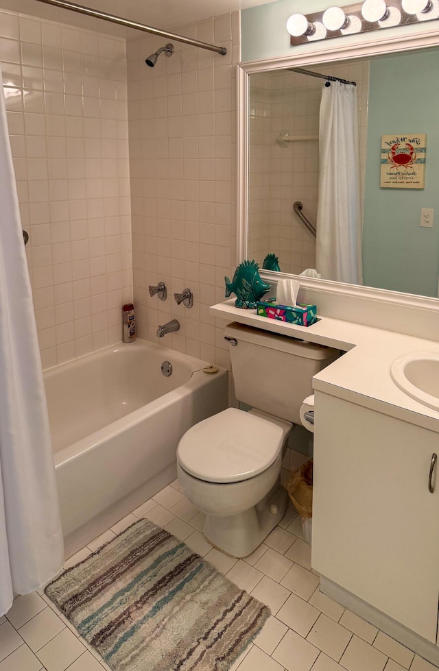 bathroom featuring shower / bath combo with shower curtain, vanity, toilet, and tile patterned floors