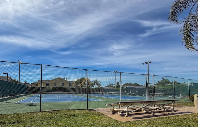 view of tennis court featuring fence